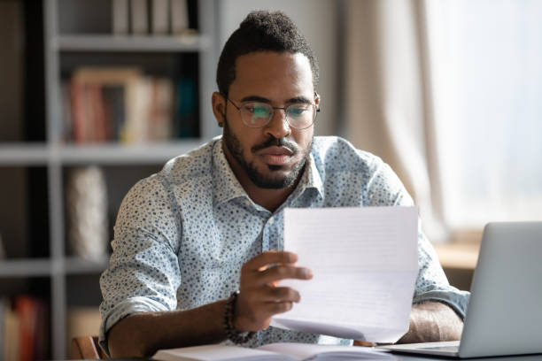istock Concentrated biracial businessman analyzing research report. 1216968902