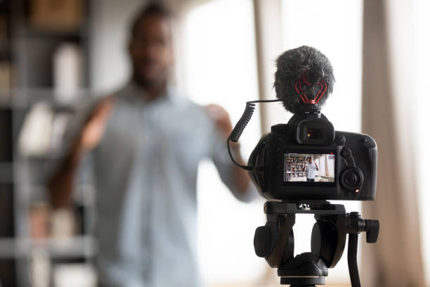 istock Close up focus on digital camera, showing mixed race man. 1216969448