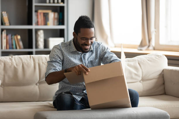 istock Happy young african male client satisfied with fast delivery service. 1216969454