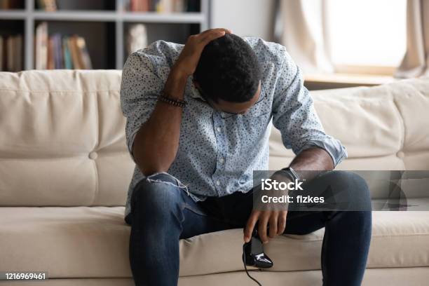 Unhappy Young Biracial Man Feeling Upset After Loosing Xbox Game Stock Photo - Download Image Now
