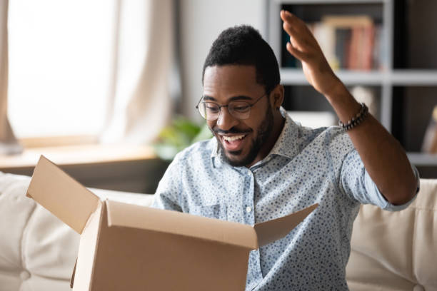 istock Young african american man feeling excited about getting wished item. 1216969462