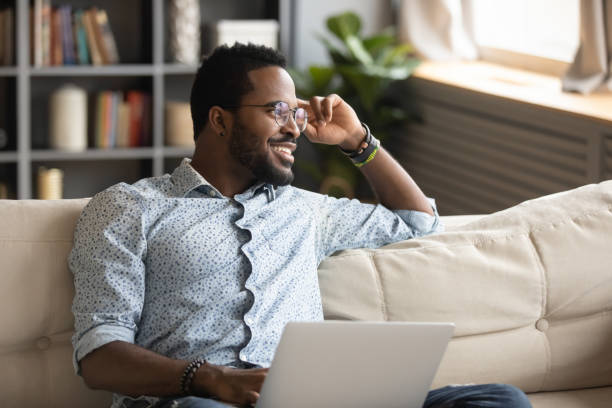 istock Positive dreamy handsome african american guy thinking of challenges. 1216969470