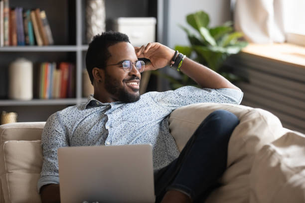 istock Multiracial freelance guy distracted from job study, looking at window. 1216969476