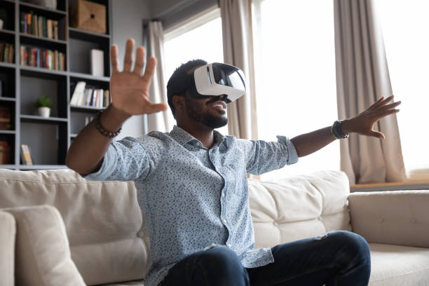 istock Overjoyed young guy enjoying spending time in virtual reality. 1216969484