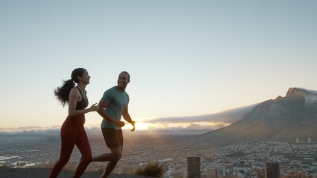Couple on a morning run on the hillside road