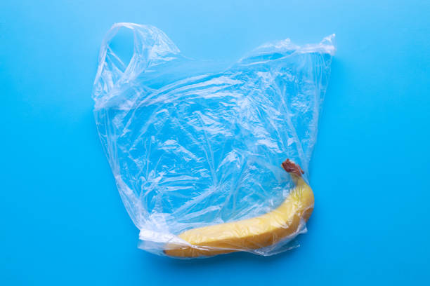 istock Plastic pollution, fresh banana in plastic bag 1216970740