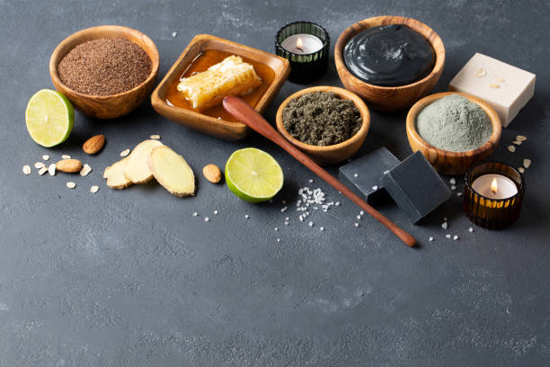 istock Spa and bath concept. Green tea scrub, ground coffee scrub, charcoal soap, blue clay, dead sea mud and other natural products for body and face beauty on a dark background. Space for text. 1216970859