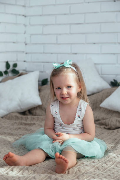 istock A little girl is sitting on the bed. 1216971010
