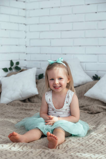 istock A little girl is sitting on the bed. 1216971016
