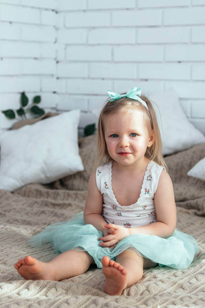 istock A little girl is sitting on the bed. 1216971018