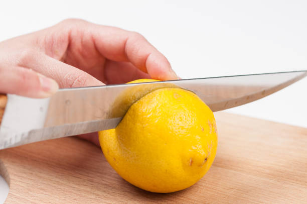 istock Lemon on cutting board isolated on white background.Copy space. 1216972436