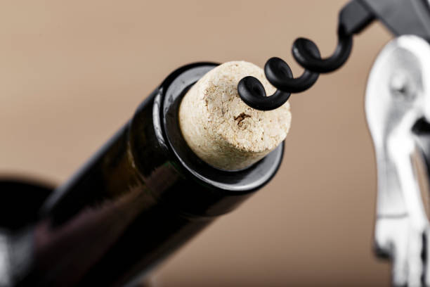 istock bottle of wine with a corkscrew in a cork, closeup. 1216972745