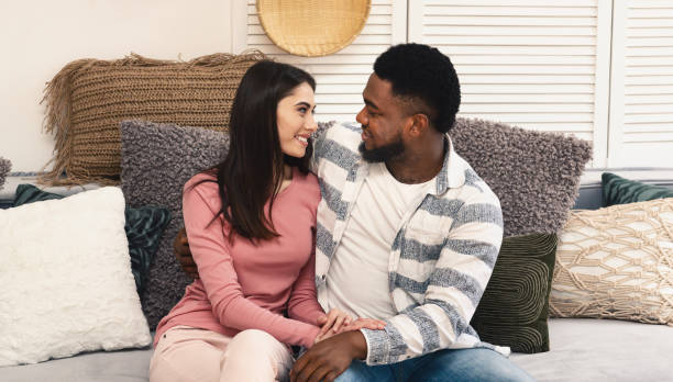 istock Husband and wife look at each other with love 1216972767