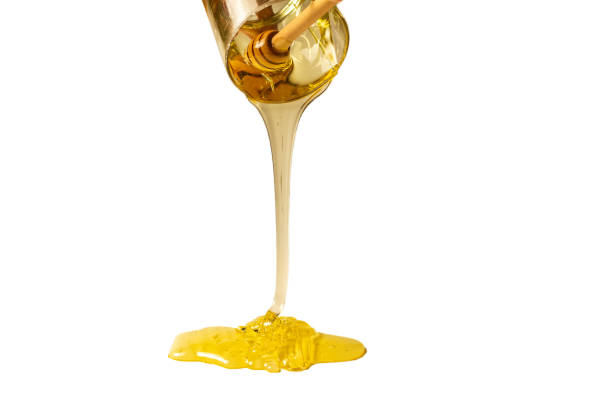 istock Dipper with honey on a white background. 1216973899