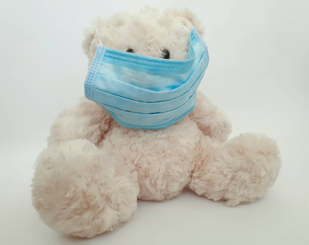 istock Teddy bear toy in a medical protective mask 1216974344