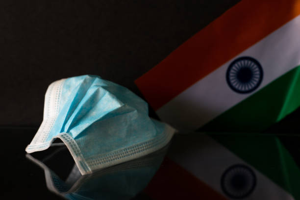 Covid-19 Pandemic Outbreak Concept Surgical face mask and Indian Flag with black background world health organization photos stock pictures, royalty-free photos & images