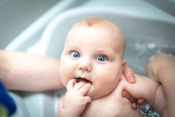 istock Mom giving her son shower at home 1216975458