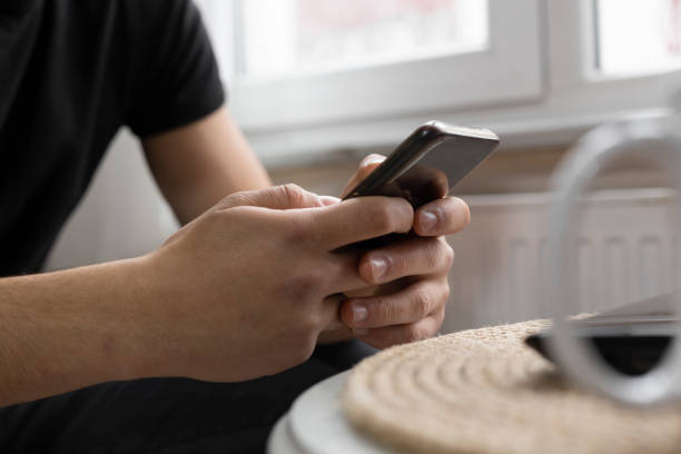 istock Teenage student surfing the internet using his smart phone 1216978072