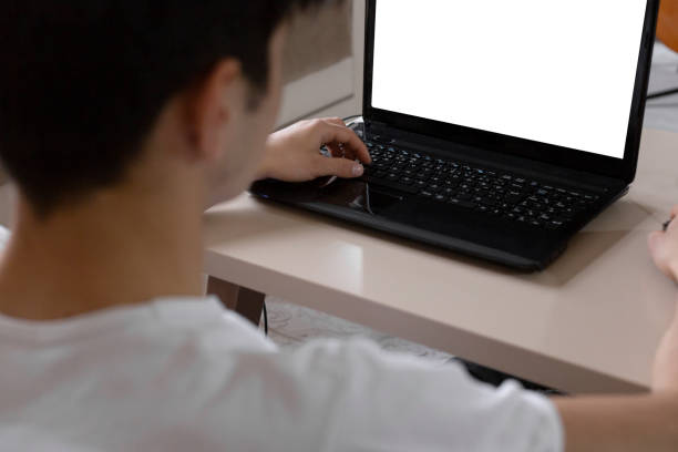 istock Teenage student studying at home using his tablet and computer 1216978153