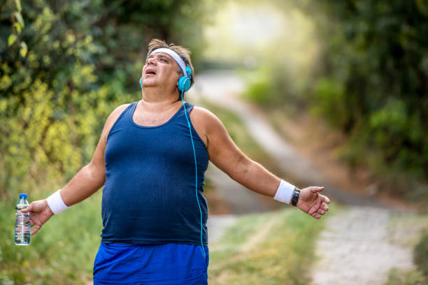 istock Overweight man slowly running outdoors, active lifestyle as struggle with obesity 1216978233