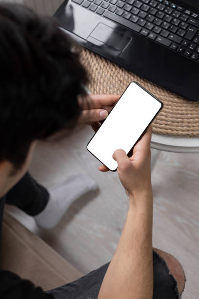 istock Teenage student surfing the internet using his smart phone 1216978970