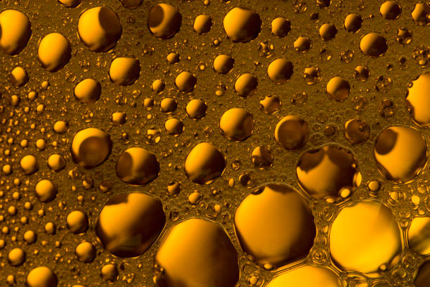 istock bubbles and drops on a orange and yellow liquid background. foam texture 1216981059