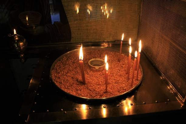 istock Lighting candles inside a Greek orthodox church. 1216981241