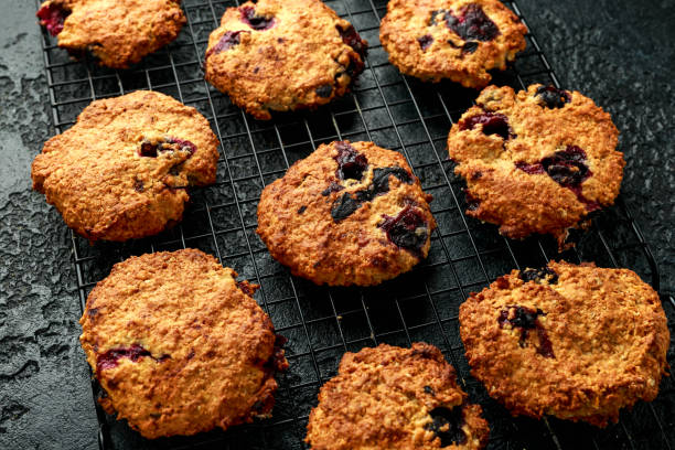 istock Home made Blueberry and walnut oat cookies on black background 1216982653