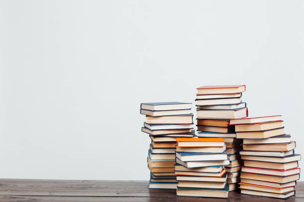 many stacks of educational books at home preparing for exams on a white background - stack of books imagens e fotografias de stock