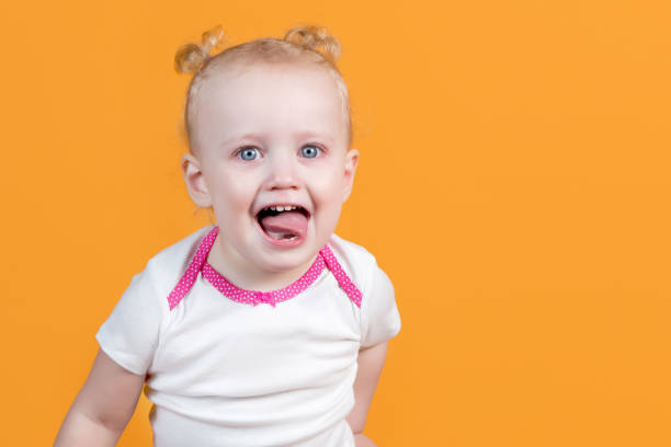 小さな女の子は熱烈に微笑み、彼女の舌を突き出す - preschooler caucasian one person part of ストックフォトと画像
