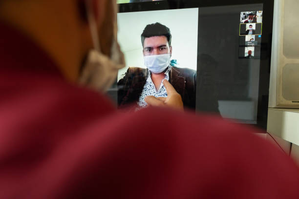 istock Co-workers have a video call, each from home and wear their masks to avoid getting COVID 19 1216984593