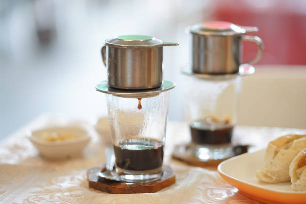 Drip coffee.  Breakfast set menu with Vietnamese dripping coffee served with buns. stock photo