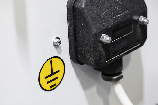 Ground wire with yellow sign, electric industrial equipment details