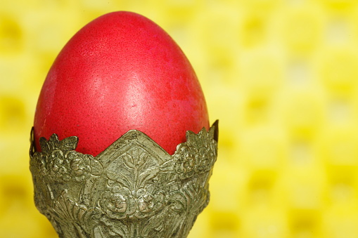 Red Eastern Orthodox Egg on an authentic silver base. Selective focus.