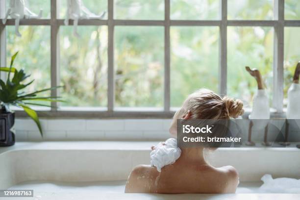 Young Adult Woman Taking Bath Holding Sponge In Hand Washed Shoulder Stock Photo - Download Image Now