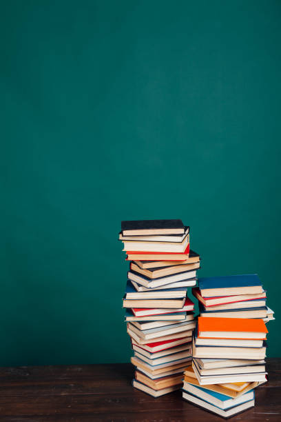 istock many stacks of educational books for learning preparation for college exams on a green background 1216987399