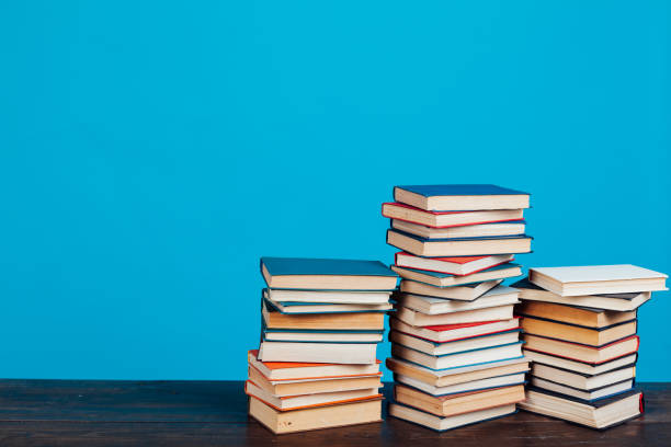 istock many stacks of educational books for learning preparation for college exams on a blue background 1216988263