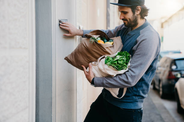 istock A man is delivering a bag of vegetables and fruit 1216988340