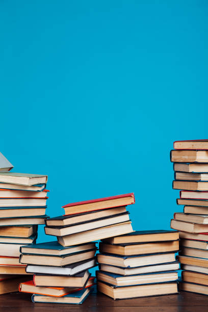 istock many stacks of educational books for learning preparation for college exams on a blue background 1216988679
