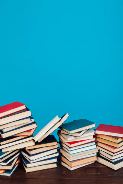 istock many stacks of educational books for learning preparation for college exams on a blue background 1216988754