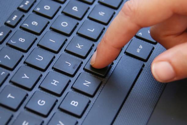 istock Finger typing in a black laptop. 1216988837