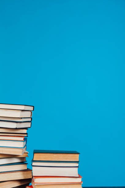 istock many stacks of educational books for learning preparation for college exams on a blue background 1216988989