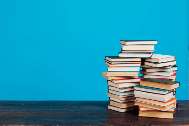 istock many stacks of educational books for learning preparation for college exams on a blue background 1216989014