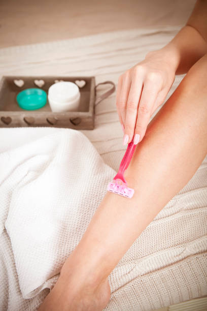 istock Crop woman shaving leg at home 1216990001