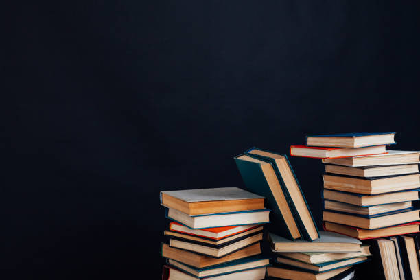 istock many stacks of educational books for learning preparation for college exams on a black background 1216990099