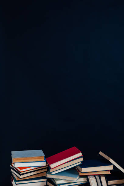 istock many stacks of educational books for learning preparation for college exams on a black background 1216990138