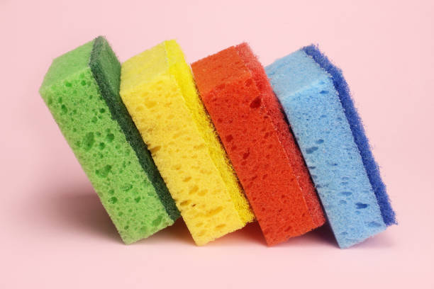 istock Colored sponges for dishes or home cleaning on a pink background 1216990245