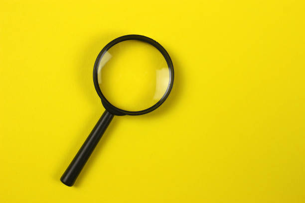 istock Magnifying glass on yellow background. Top view. Copyspace for your text 1216990324