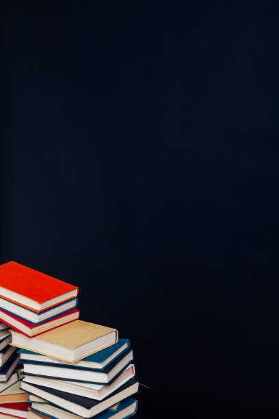 istock many stacks of educational books for learning preparation for college exams on a black background 1216990326
