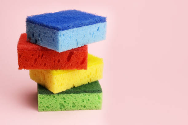 istock Colored sponges for dishes or home cleaning on a pink background 1216990338